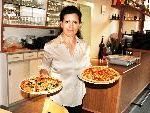 Leonora serviert in der ,,Casa mia" Pizze.