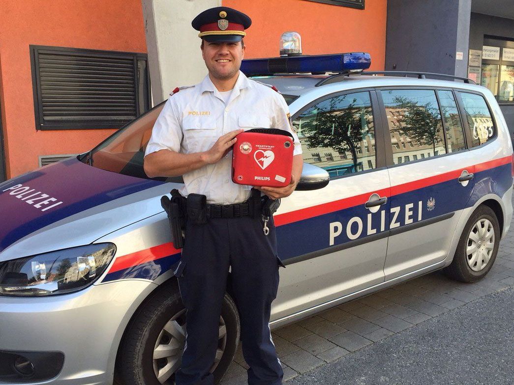Inspektor M. hält stolz einen lebensrettenden Defibrillator in der Hand. Inspektor M. hält stolz einen lebensrettenden Defibrillator in der Hand.